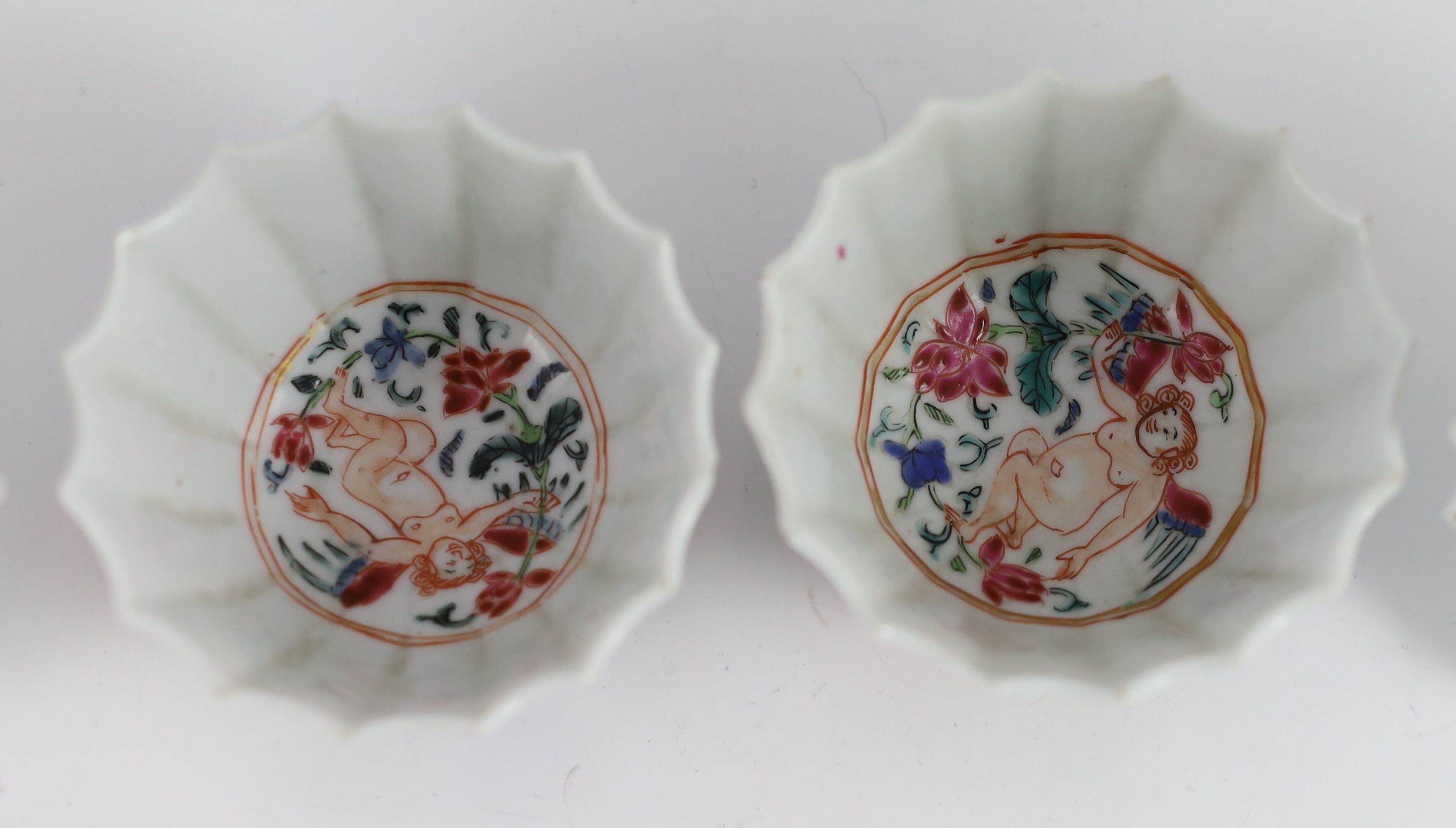 A pair of Chinese famille rose petal fluted tea bowls and saucers, Yongzheng period, saucer 10.5cm diameter